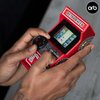 Thumbs Up Mini Arcade Racing Machine: Handheld Console with 30 Pre-Loaded 8-Bit Games, 2.4" LCD Screen, Steering Wheel, Gear Stick, Control Buttons, Games Console