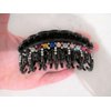 Black curved hair claw clip with multi-color crystals and double grip