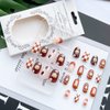 KOLONAMS Flower Press on Nails Short Almond Shape Brown Fake Nails Flowers Hearts Lattice Tai Chi Smiley Face Design Acrylic Artificail French False Nails Full Cover Glue on Nails for Women 24 Pcs
